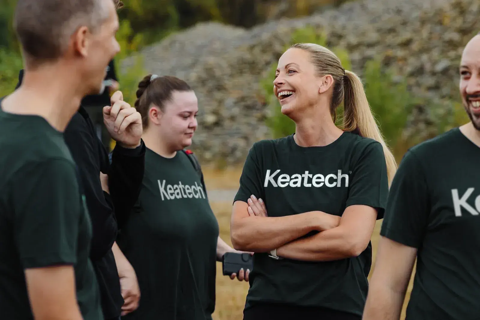 Keatech team members laughing in branded shirts