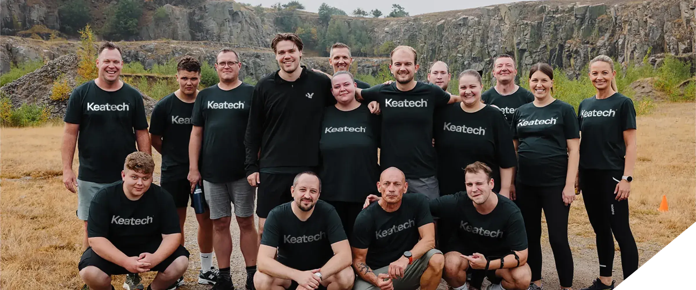 Keatech team members wearing company t-shirts, gathered together outdoors