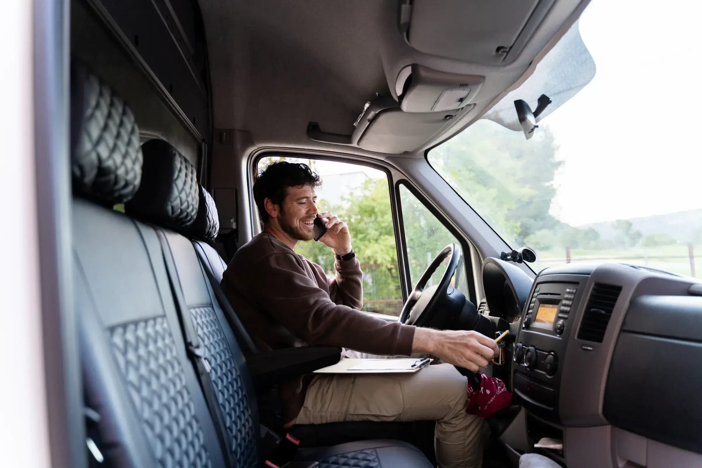 Driver in truck cab using laptop